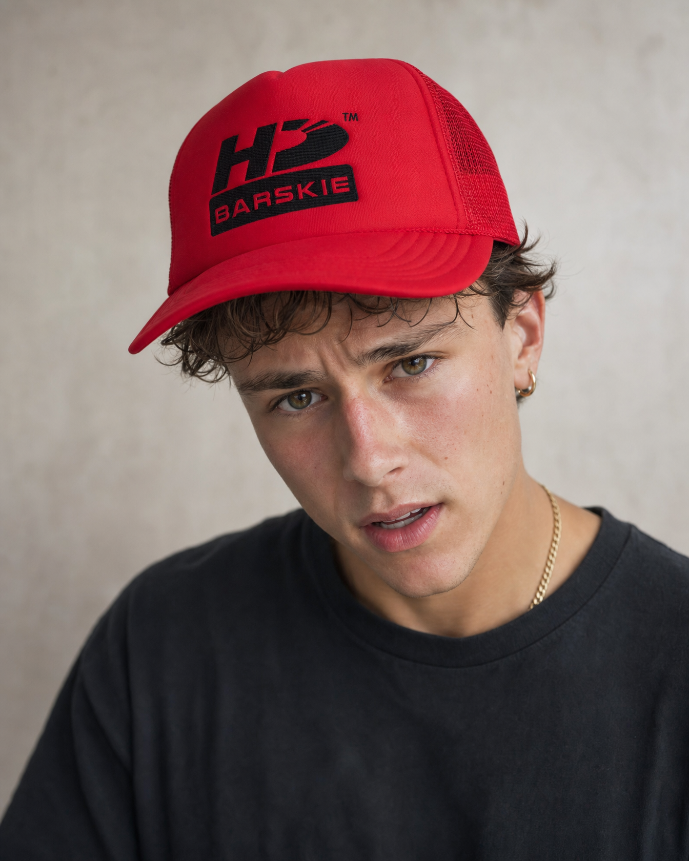 HDB Foam Trucker Hat worn by Bam in a close-up graphic lookbook shot