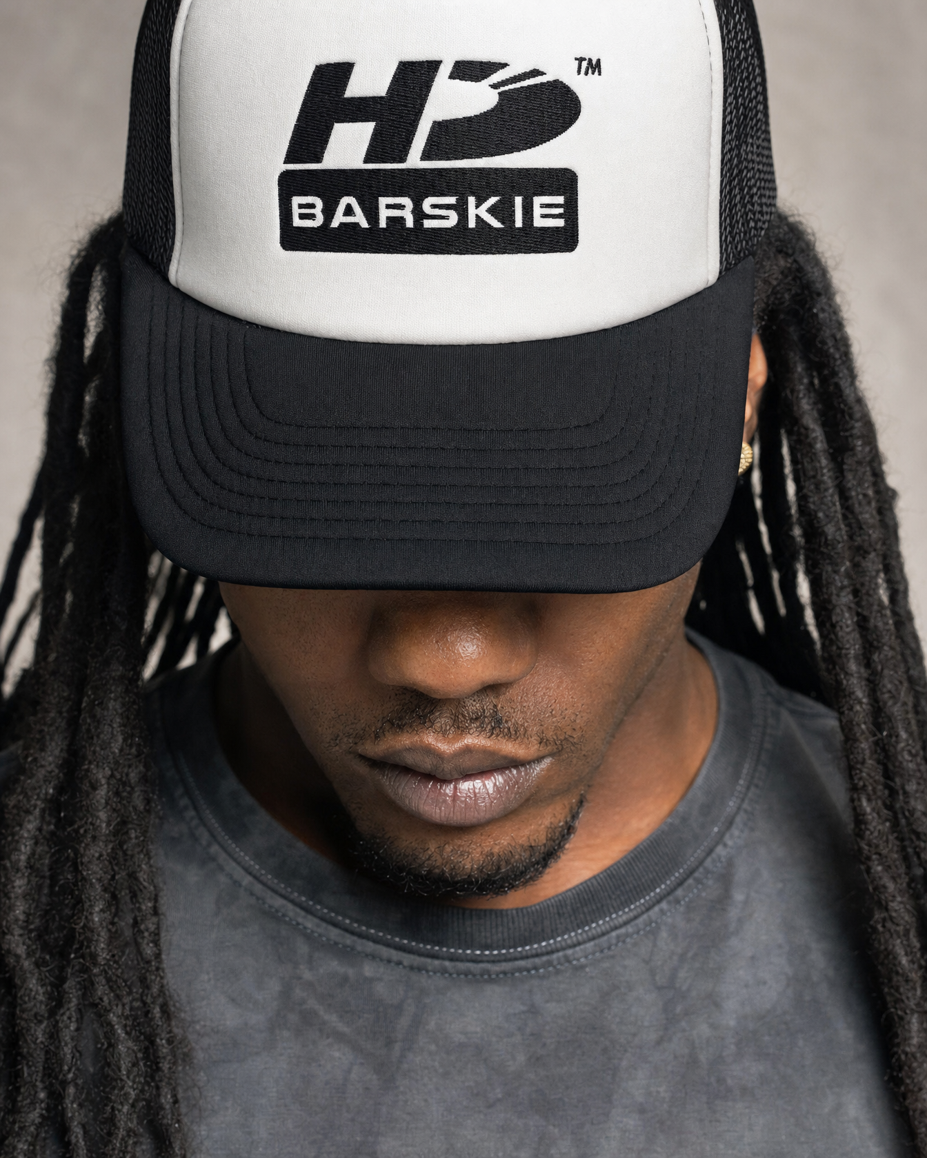 HDB Foam Trucker Hat worn by Barskie in a close-up graphic lookbook shot