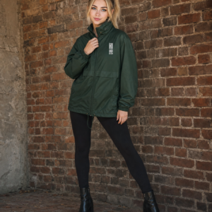 HIDEF All-Weather Windbreaker worn by Harper against a brick wall, lookbook shot