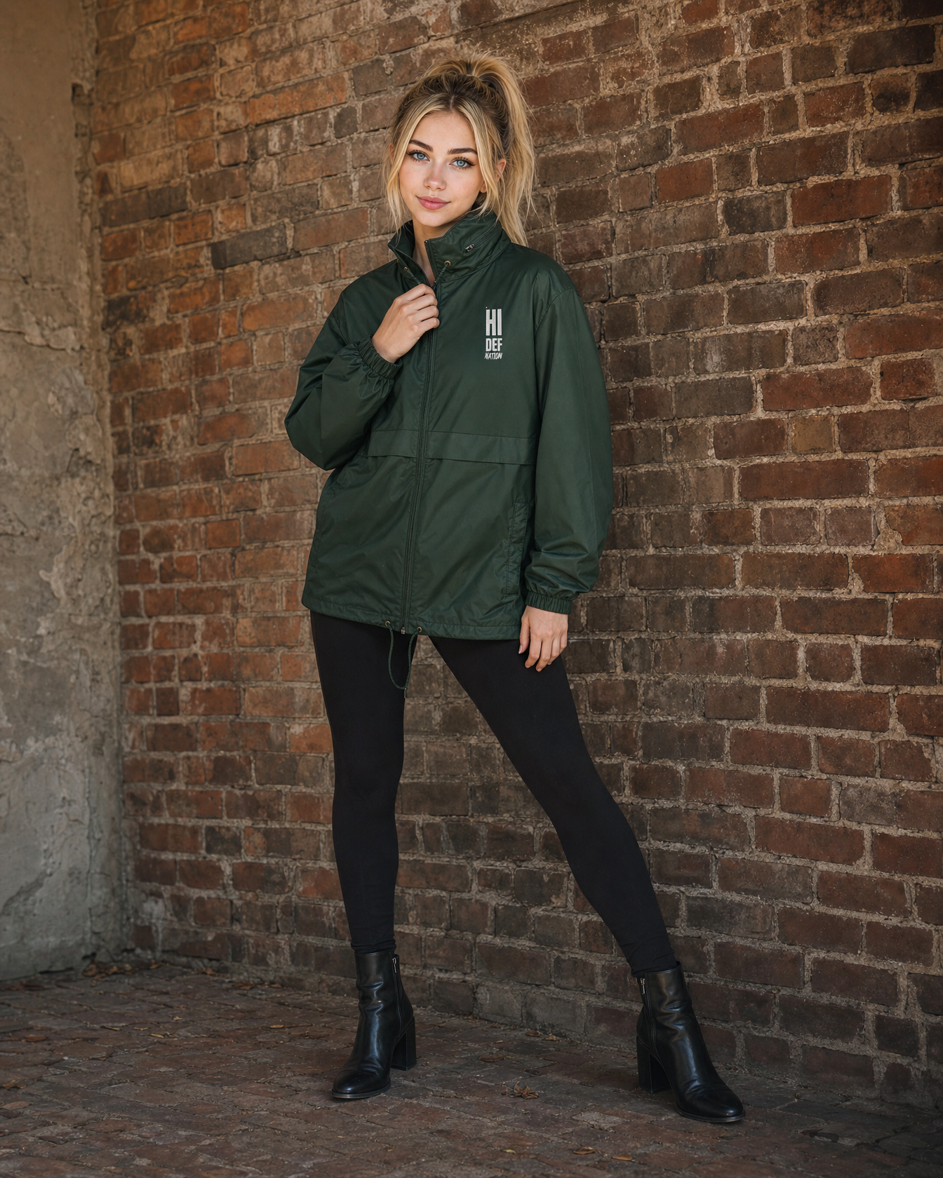 HIDEF All-Weather Windbreaker worn by Harper against a brick wall, lookbook shot